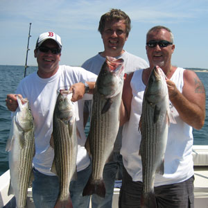 Three Men Holding Fish