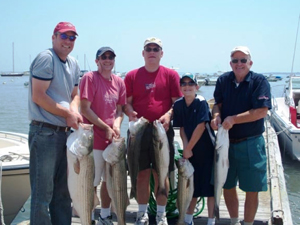 Four Men and Boy Holding Fish